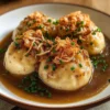 Classic potato dumplings with onion sauce
